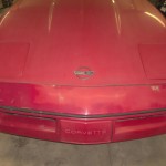 A red 1984 C4 Corvette before being restored. It's been repainted in places at least once.